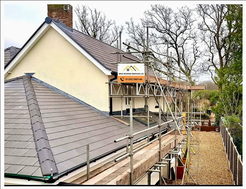 Apex Roofing banner and logo on a building with scaffolding during roof repairs in Bournemouth